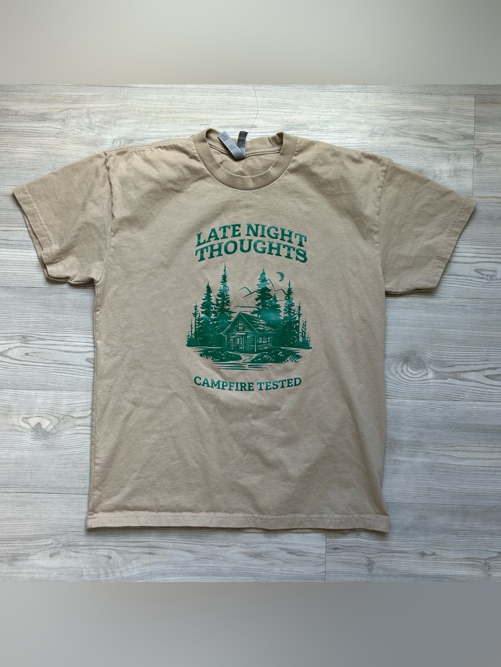 Next Level Apparel Tan Tee with Green Campfire Graphic
